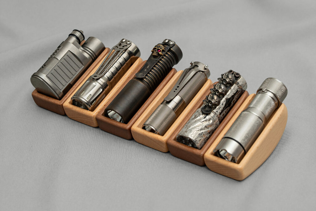 Beam Stand Wood stands in ash and walnut holding a row of flashlights