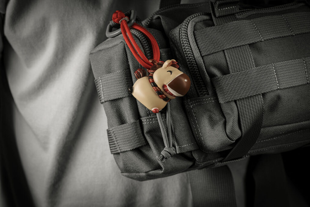 Dawn Hoof Charm in Zen Abode hanging from a grey bag