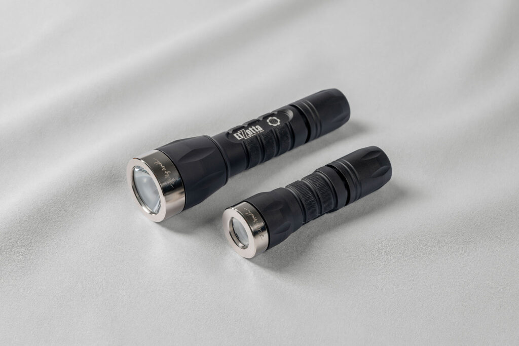 Two Elzetta flashlights fitted with Jelly Smith stainless steel bezels